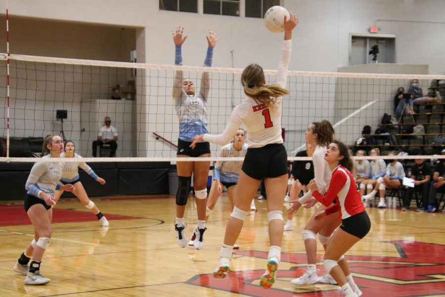 Senior Laure Roskein spikes the ball over the net. 