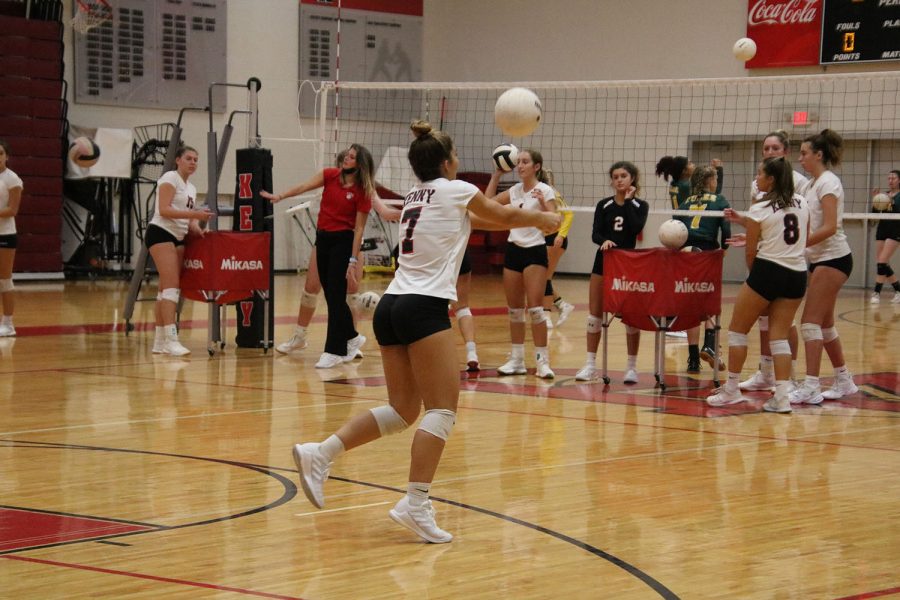 Junior Isabella Miller bumps the ball during warmup.