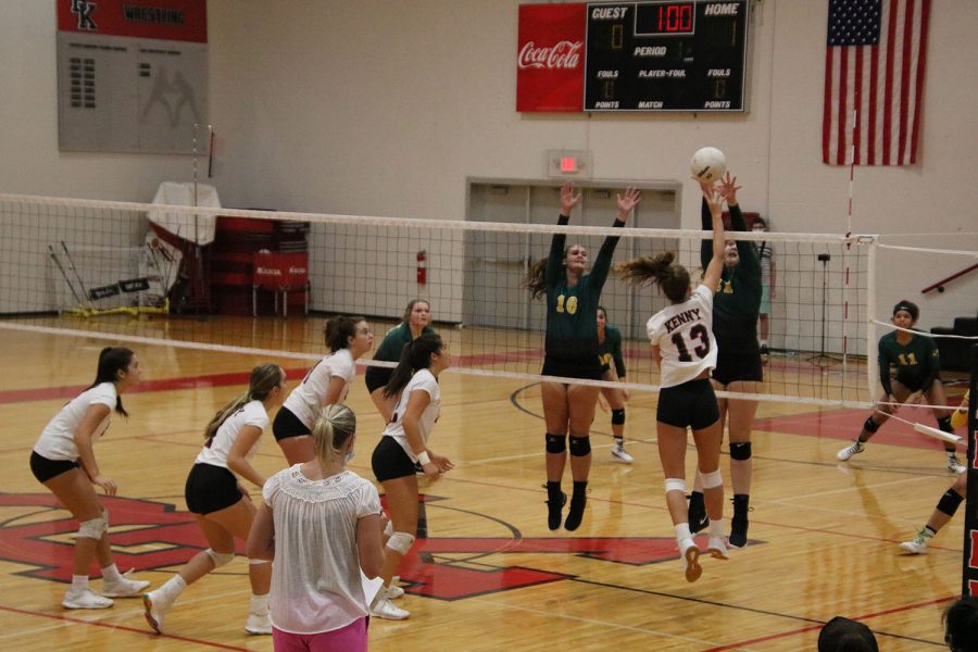 Senior Ashton Dilts tips the ball over the net.