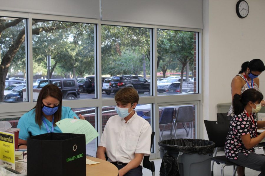 Junior Nolan Beenen waits for his flu shot to be given to him.