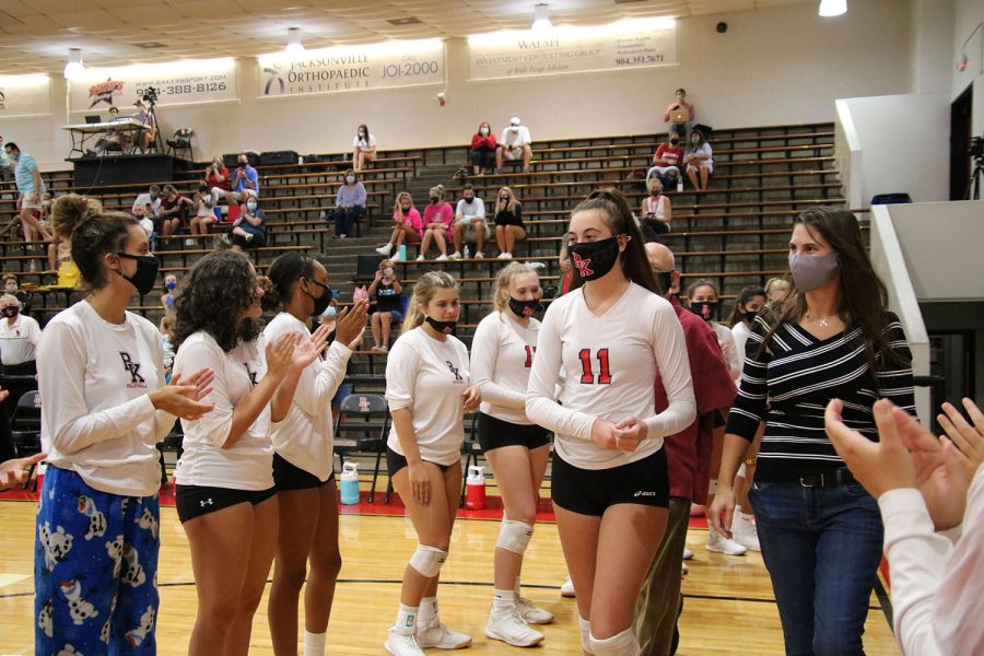 Senior Emma Fraidenburg walks on the court for Senior Night.