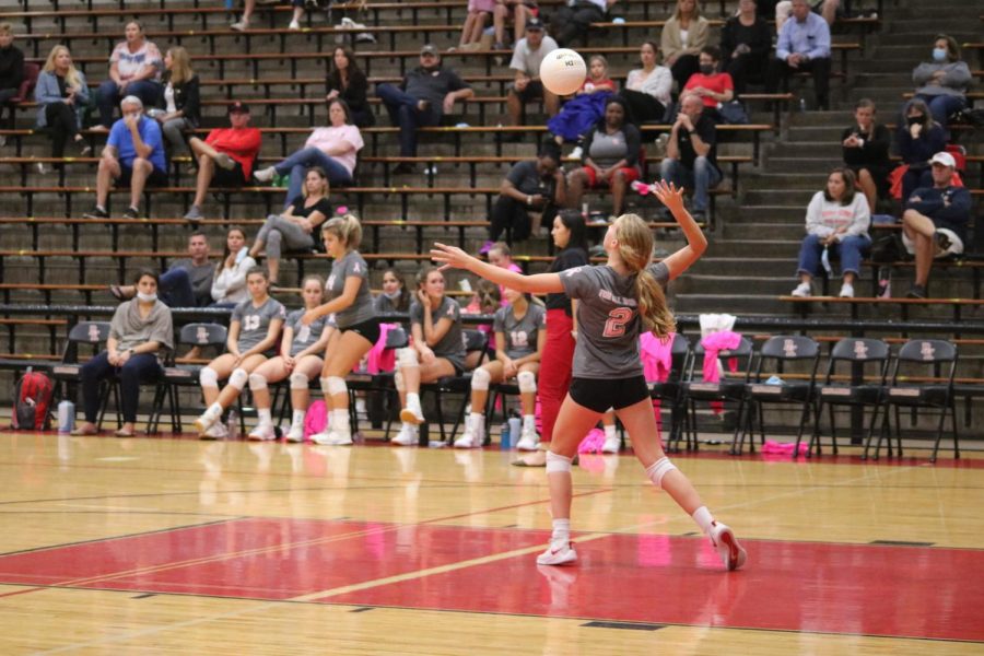 Sophomore Audrey Perry spikes the ball over the net.