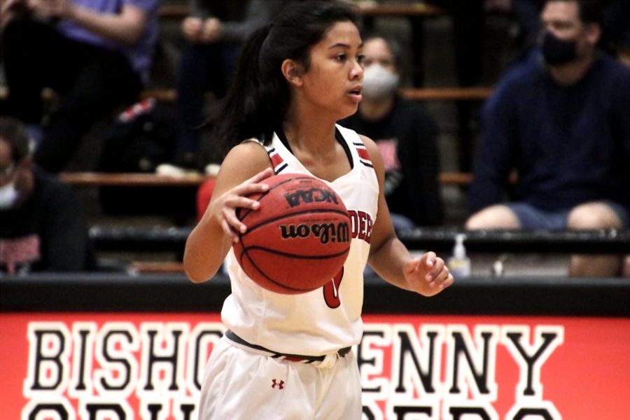 Freshman Isabelle Dionisio dribbling the ball across court in an offensive play. 