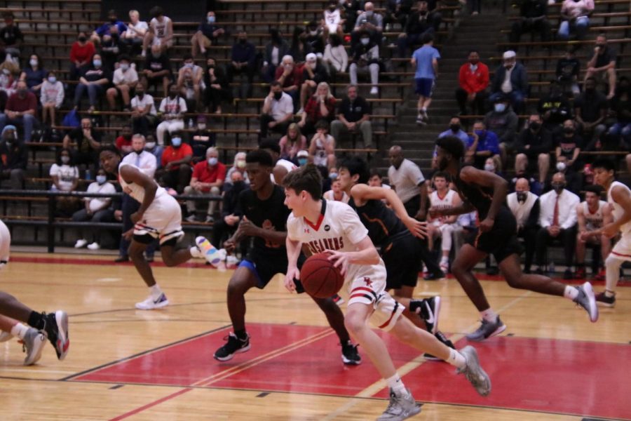 Senior Daniel Buckley dribbles the ball to the other side of the court in an attempt to make a basket.