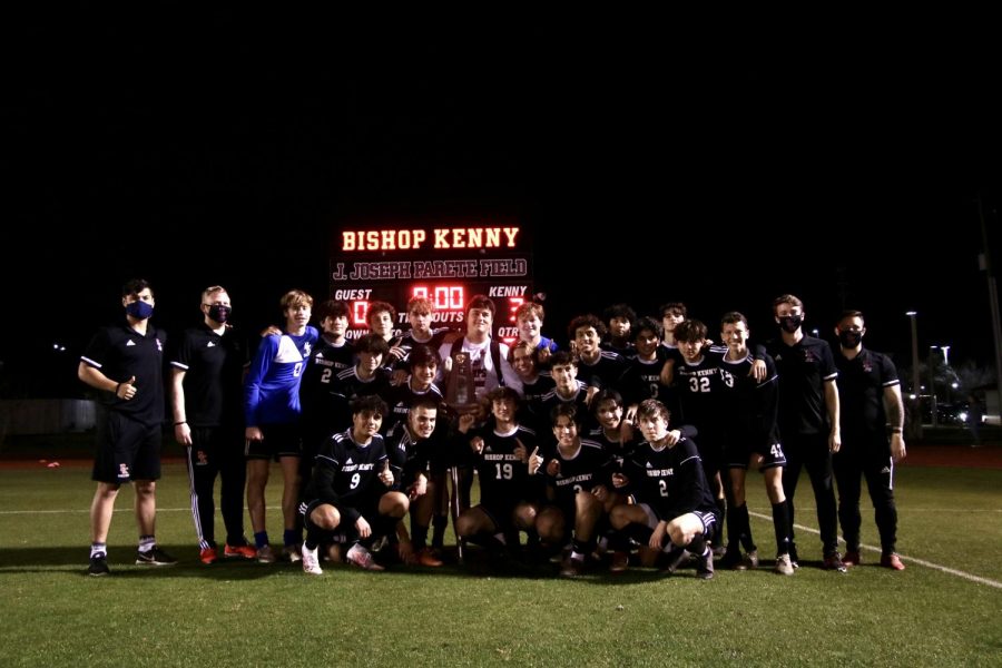 Crusaders boys soccer team including coaches and managers posing in front of their 3-0 win. 