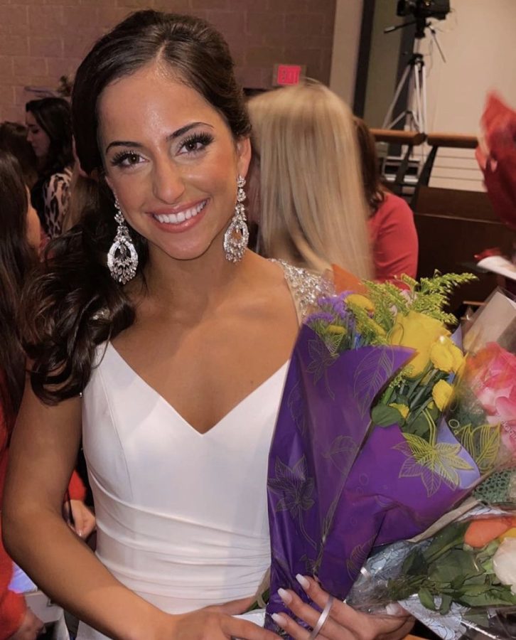 Senior Sophia Parry smiles holding flowers after the pageant.  (Photo Courtesy of Sophia Parry)
