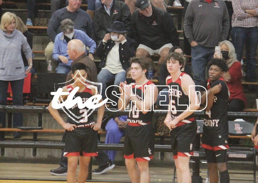 Teammates Diego Dionisio, Drew McAtee, Gavin Meehan, and Justin Gist support their team from the sidelines.