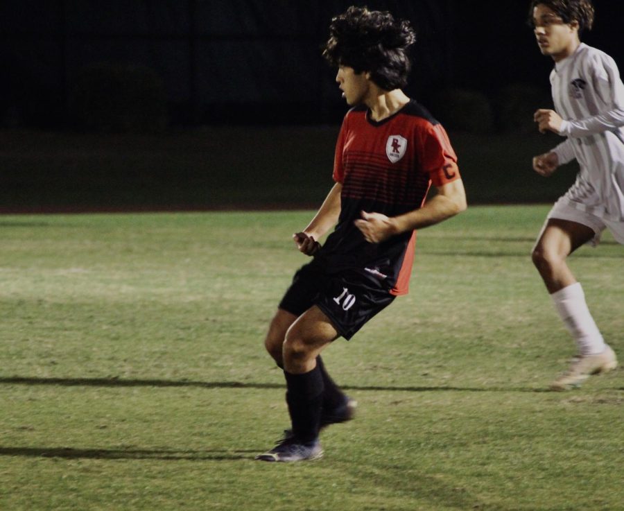 Senior Patrick Russell runs across the field.