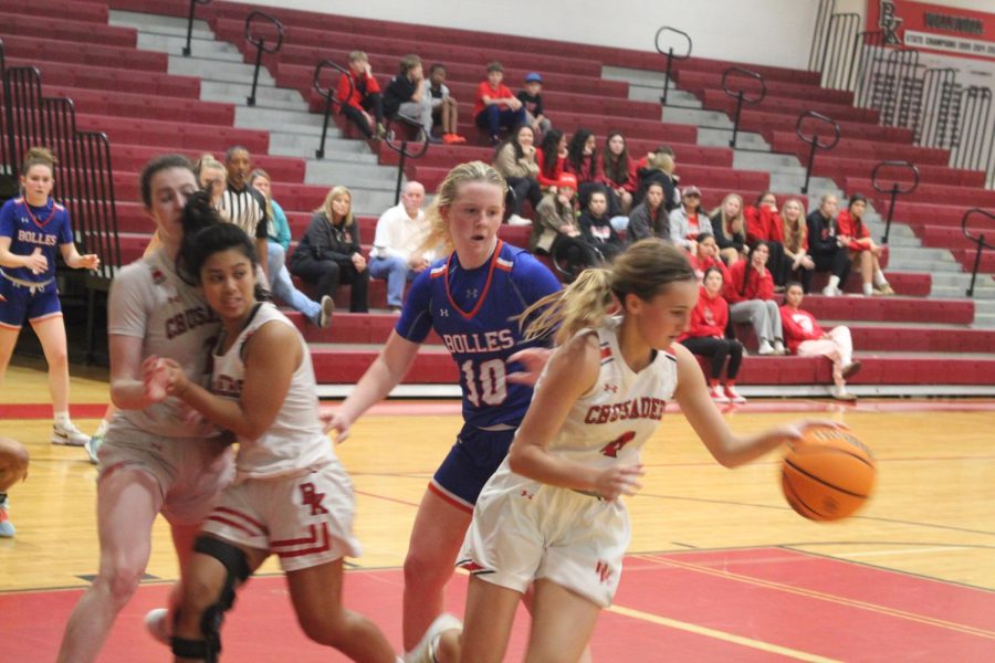 Sophomore Reese Mayer grabs the ball and drives it out.