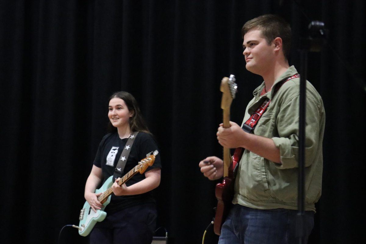 Junior Caroline Kartsonis and senior Logan Ellzey smile towards the crowd after finishing one of their many performances 