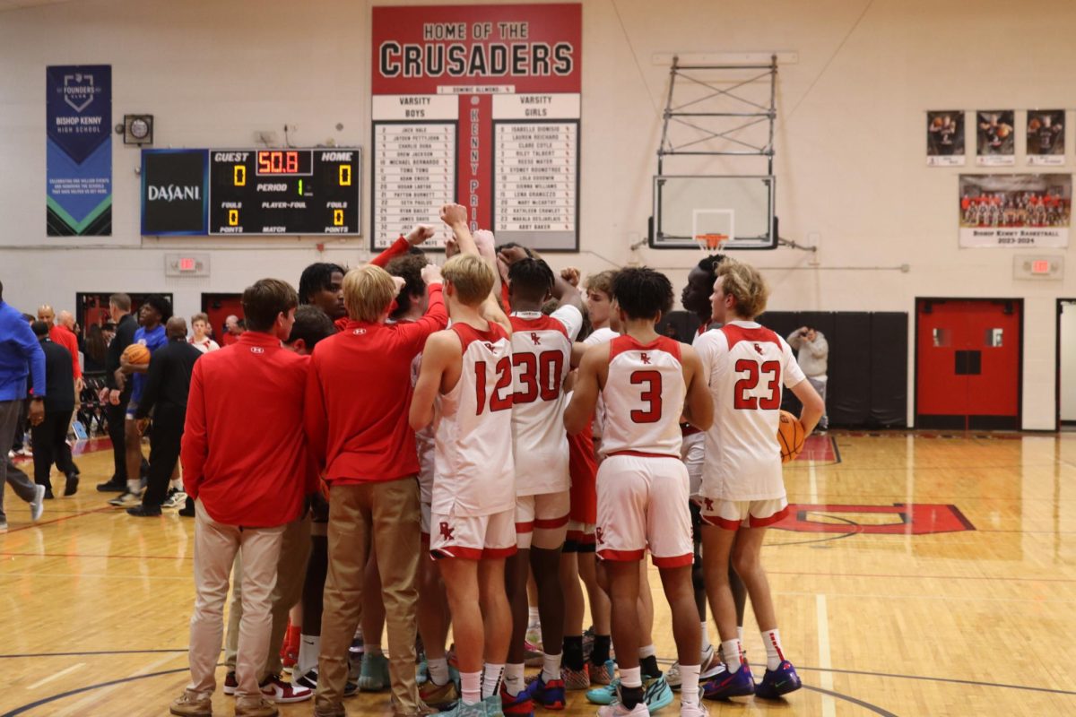 The varsity boy's team huddles moments before the game starts.