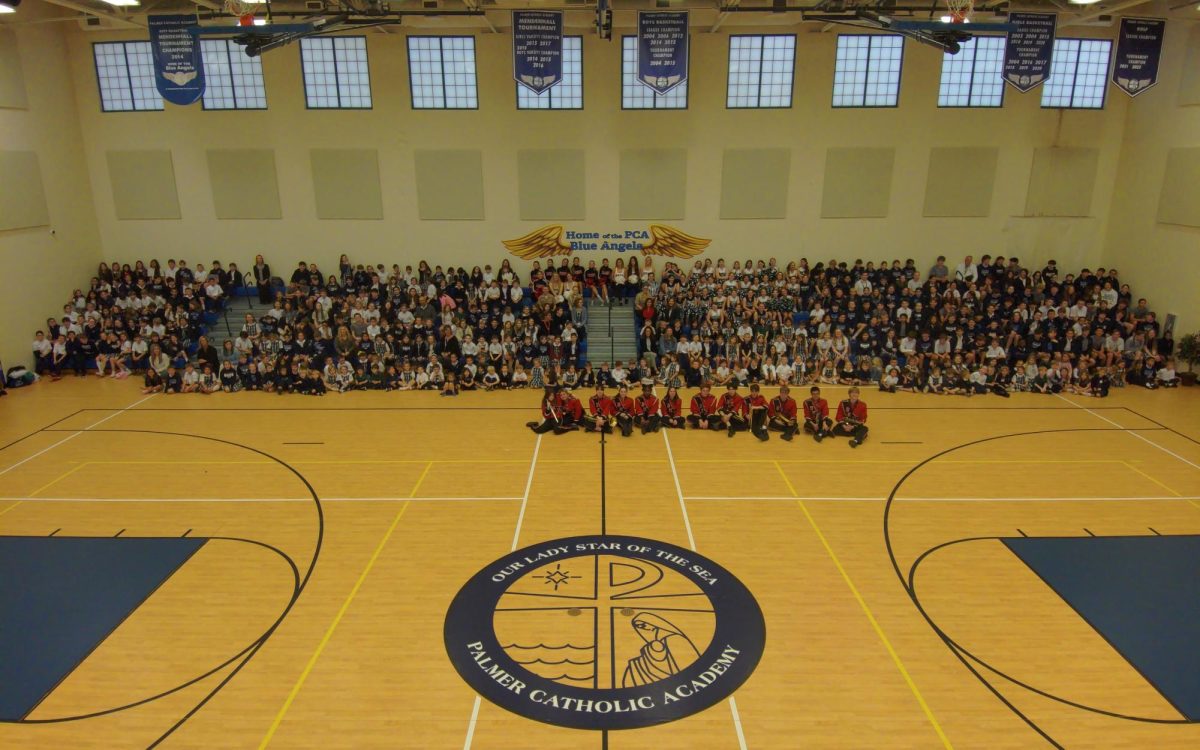 NJROTC, Dance, Cheer and Band pose with Palmer Catholic Academy for a photo.