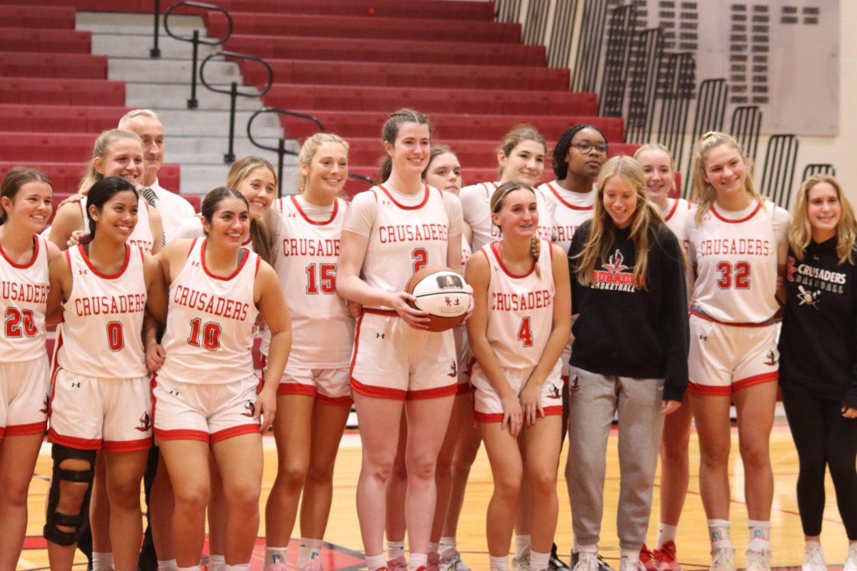The whole team comes on the court to celebrate Clare Coyle in her big accomplishment of 1,000 points.