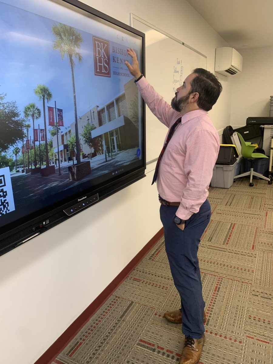 Director of Technology, Larry Rodriguez uses the Promethean board to set up for a class. 