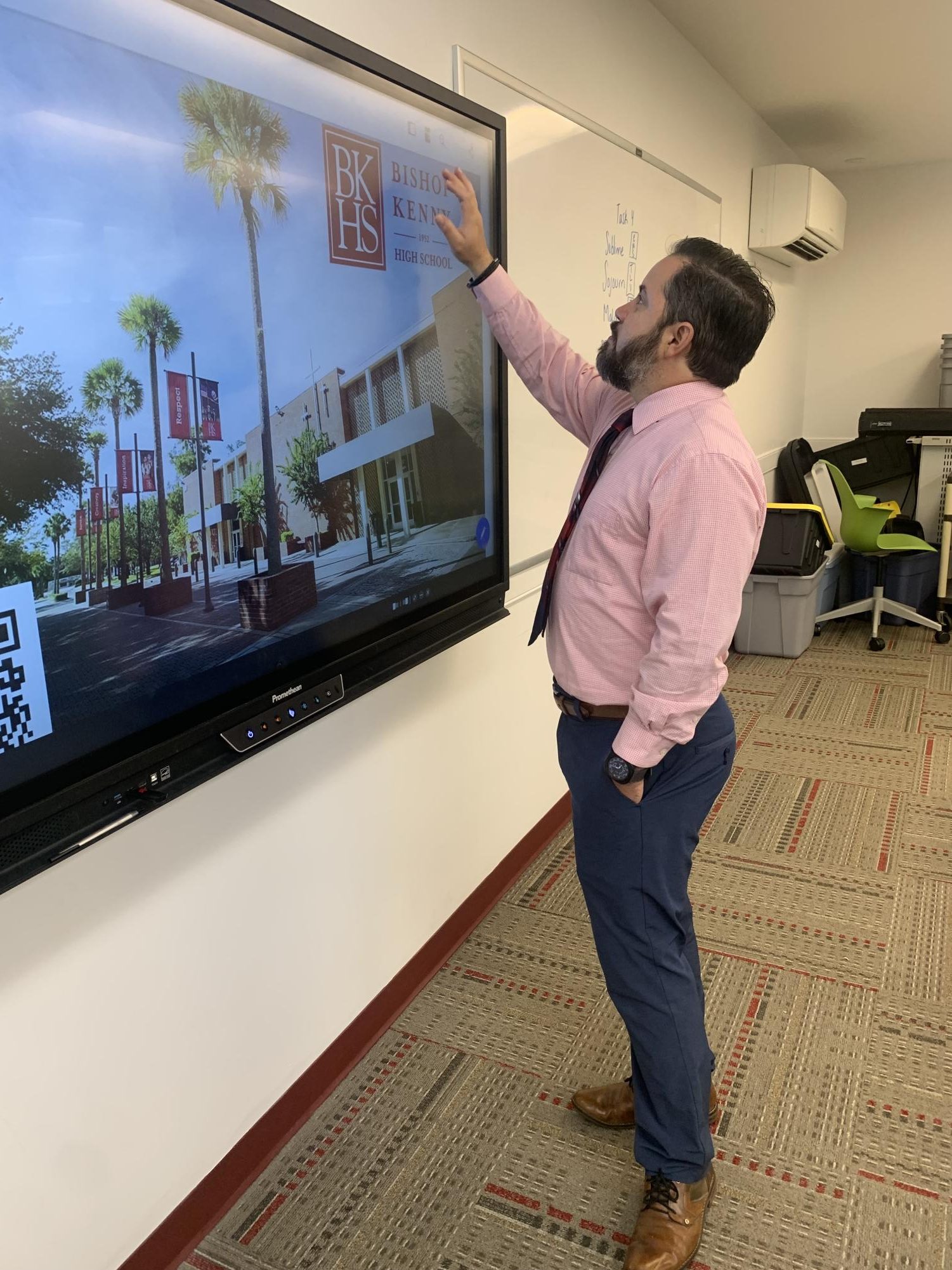 Director of Technology, Larry Rodriguez uses the Promethean board to set up for a class. 