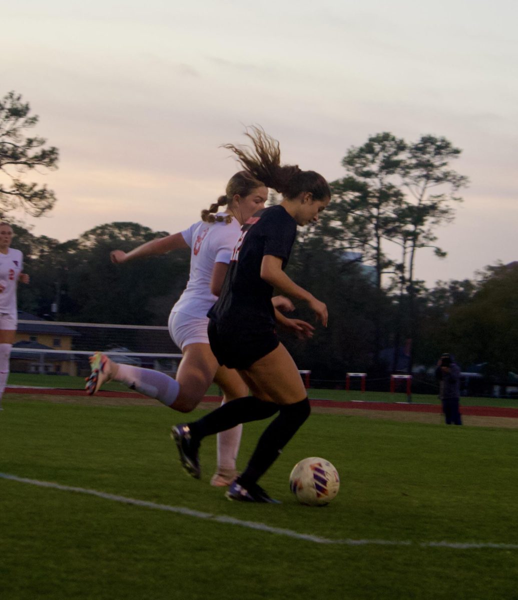 Senior Stella Jones dribbles toward the goal in the regional final game against the Vanguard Knights on Tuesday, February 17.