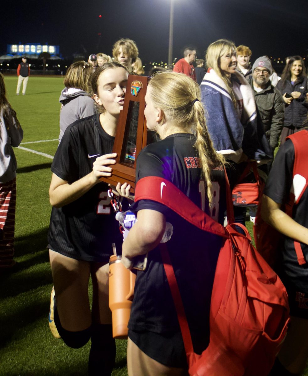 Seniors Cate Petre and Anna Perry celebrate there 5-1 win in the regional finals against the Vanguard Knights on Tuesday, February 17. 