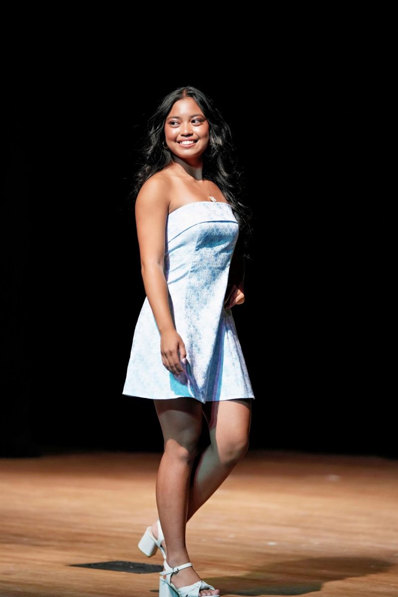 Contestant #2, Kara Odavar, beams at the crowd as she models her casual wear dress.
