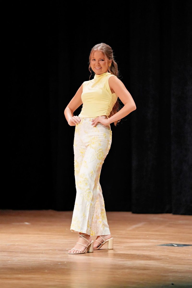 Seanna Mead brightens the room in a yellow top and pants during casual wear.