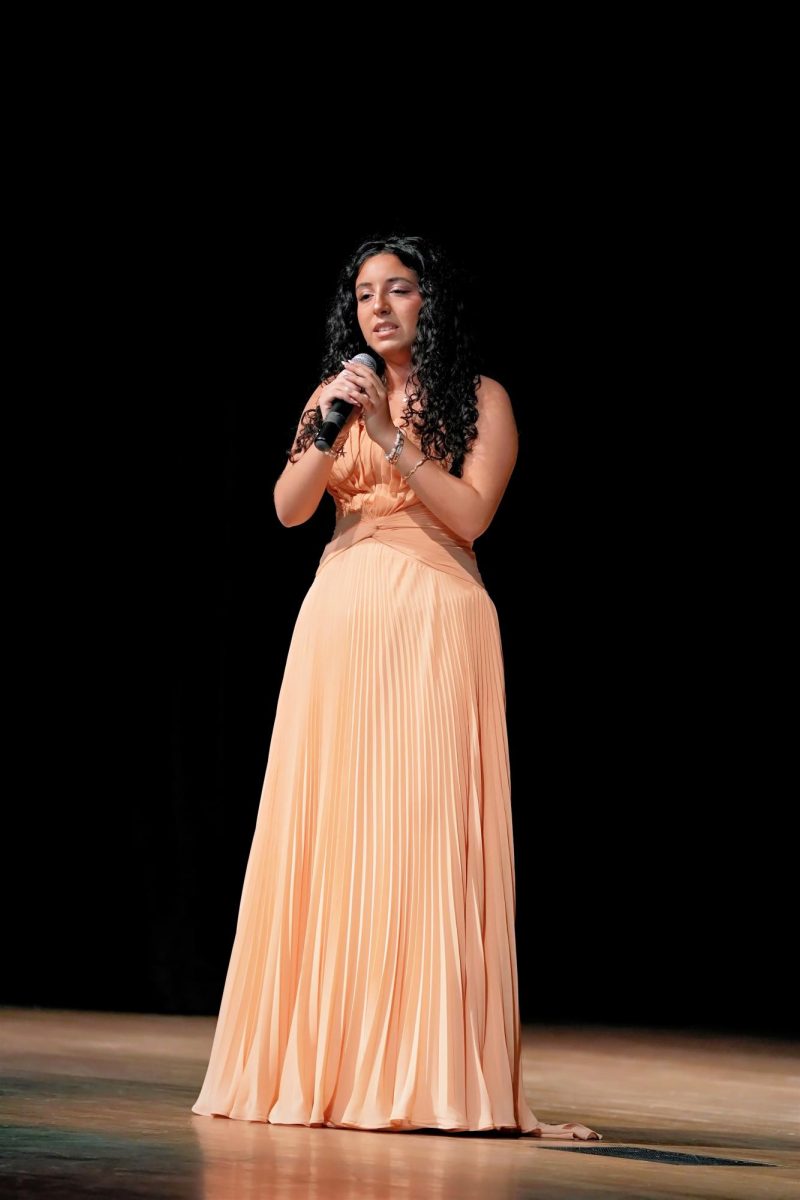 As special entertainment for the crowd, senior Julie Sanam sings “Burn,” from the Broadway musical, “Hamilton.”