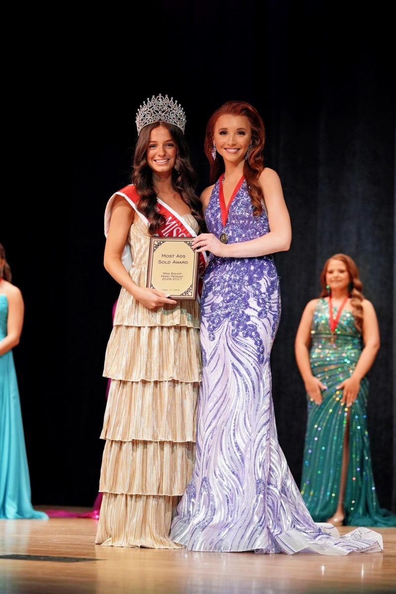 Sheridan Delegal presents Everly Wade with Most Sales Award for selling the most advertisements in the program book, raising more than $1,500 in support of the pageant.